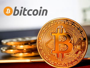 Imagen con el logo de bitcoin y una moneda en primer plano