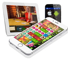 Se ven varios dispositivos portátiles con diferentes juegos de casino en la pantalla, como la tragaperras Aloha! y una mesa de blackjack con una crupier rubia.